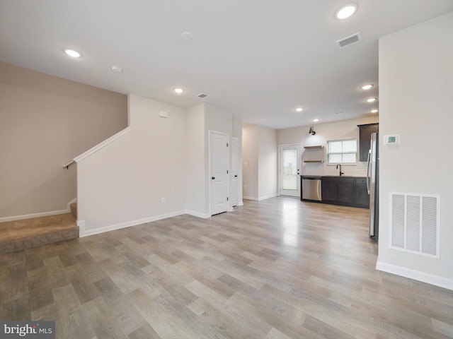 38 Preening Rd, Hedgesville, WV 25427 - unfurnished living room with recessed lighting, light wood-style floors, and stairs