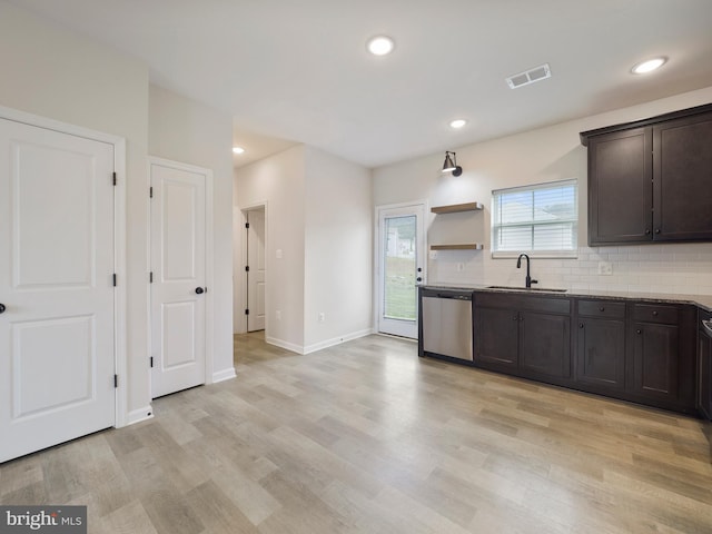 38 Preening Rd, Hedgesville, WV 25427 - kitchen with stainless steel dishwasher, decorative backsplash, light wood-style flooring, dark brown cabinets, and stone counters