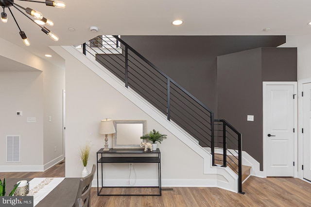 512 Marshall Ave, Pikesville, MD 21208 - stairs with wood finished floors, recessed lighting, and a chandelier