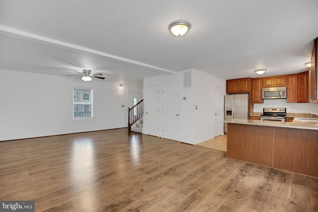 40534 Miss Ettas Way, Leonardtown, MD 20650 - kitchen featuring appliances with stainless steel finishes, ceiling fan, light wood-style flooring, and brown cabinets