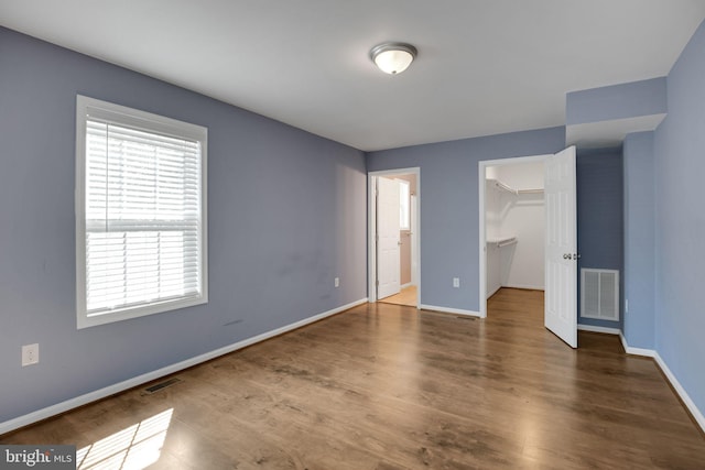 40534 Miss Ettas Way, Leonardtown, MD 20650 - unfurnished bedroom featuring wood finished floors, a spacious closet, and a closet