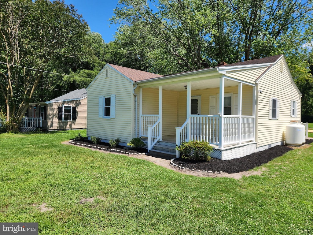30483 Bennett Rd, Salisbury, MD 21804 - view of front facade with a porch, a front lawn, and a shingled roof