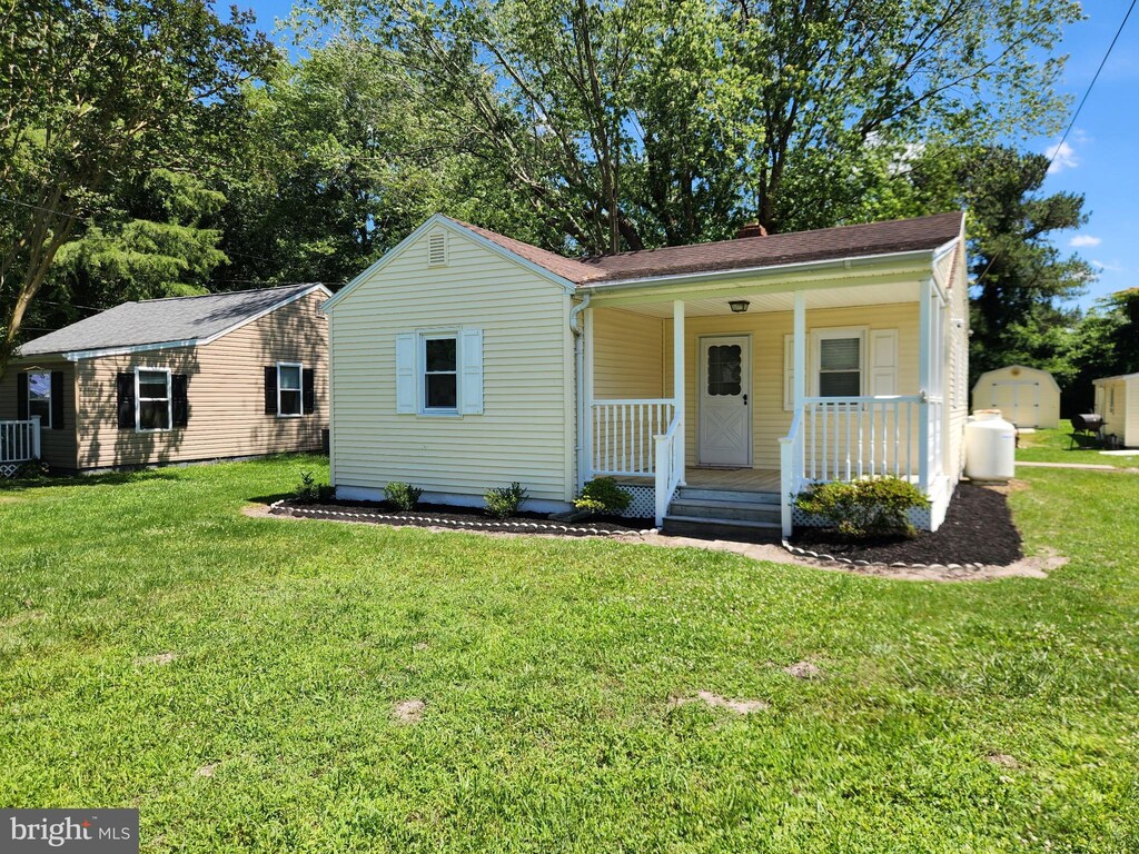 30483 Bennett Rd, Salisbury, MD 21804 - view of front facade with a porch and a front lawn