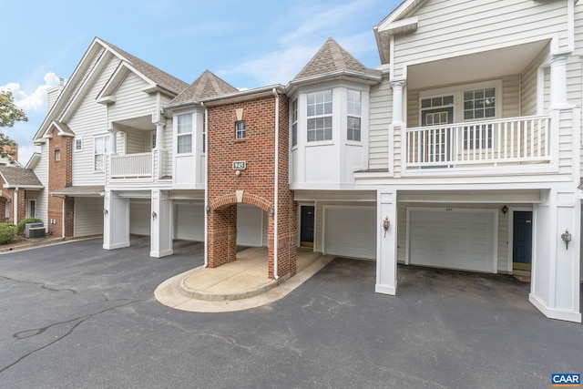 945 Dorchester Pl Unit 306, Charlottesville, VA 22911 - view of property featuring a garage, driveway, a balcony, and brick siding