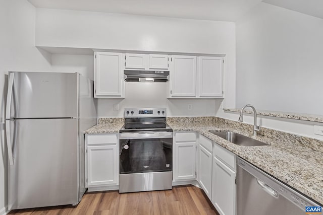 945 Dorchester Pl Unit 306, Charlottesville, VA 22911 - kitchen featuring stainless steel appliances, under cabinet range hood, light stone countertops, light wood finished floors, and white cabinetry