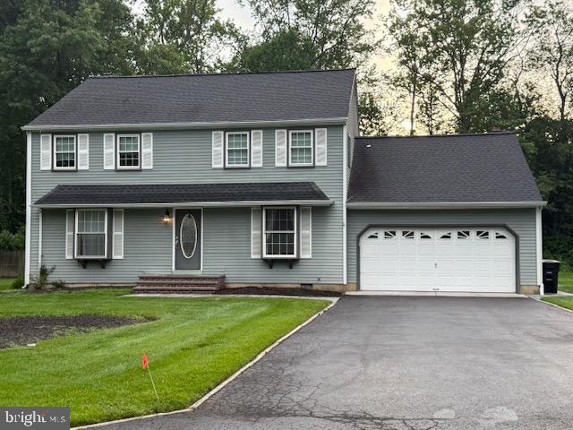 10 Bayau Trl, Medford, NJ 08055 - view of front facade with an attached garage, driveway, and a front lawn