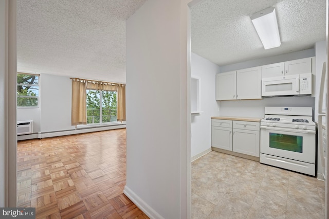 1030 E Lancaster Ave Unit 806, Bryn Mawr, PA 19010 - kitchen featuring white appliances, a textured ceiling, baseboard heating, white cabinets, and light countertops