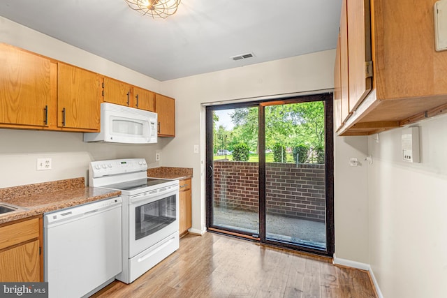 19 Juliet Ln Unit 103, Baltimore, MD 21236 - kitchen with white appliances, light wood-style flooring, light countertops, and brown cabinets