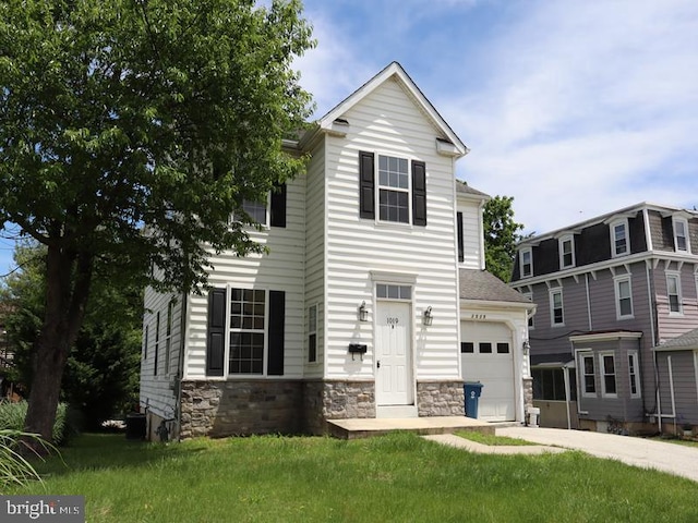 1019 Lafayette Ave, Prospect Park, PA 19076 - view of front of home featuring an attached garage, stone siding, a front yard, and driveway