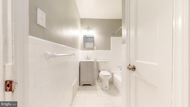 1126 Gleneagle Rd, Baltimore, MD 21239 - bathroom featuring vanity, washtub / shower combination, wainscoting, and tile walls