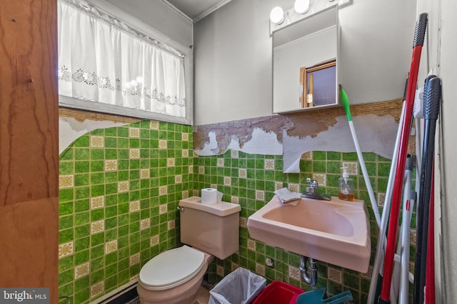 65 Silverspruce Rd, Levittown, PA 19056 - bathroom with ornamental molding, tile walls, wainscoting, and baseboard heating