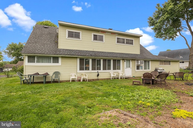 65 Silverspruce Rd, Levittown, PA 19056 - back of property featuring a shingled roof and a yard