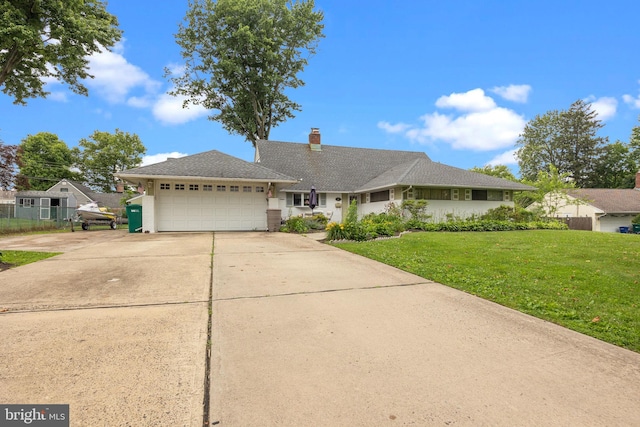 65 Silverspruce Rd, Levittown, PA 19056 - ranch-style house featuring an attached garage, driveway, a front lawn, and a chimney