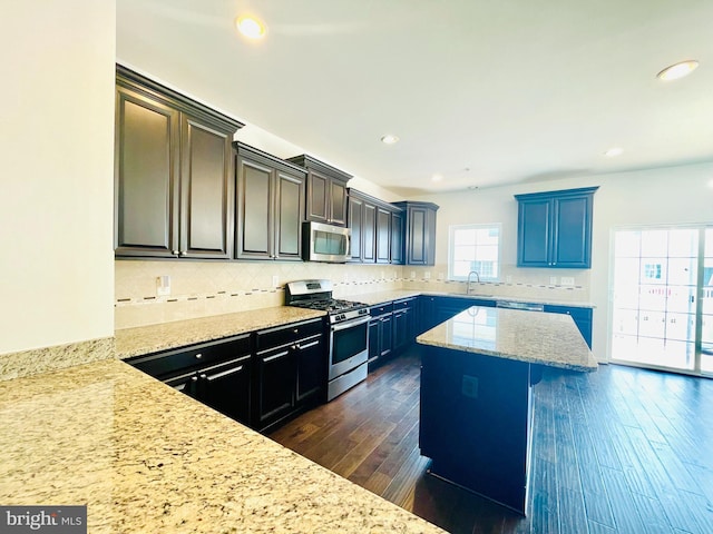7120 Beaumont Pl, Hanover, MD 21076 - kitchen featuring appliances with stainless steel finishes, dark wood-style flooring, tasteful backsplash, light stone countertops, and recessed lighting