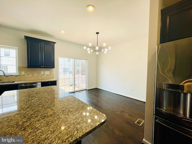 7120 Beaumont Pl, Hanover, MD 21076 - kitchen with a chandelier, plenty of natural light, light stone countertops, dark wood finished floors, and recessed lighting