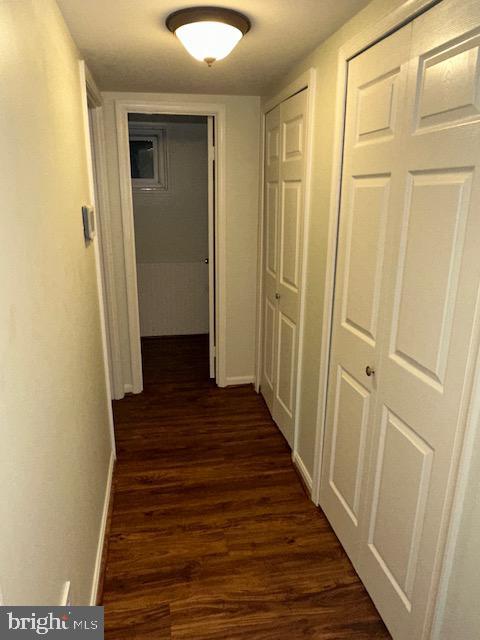 11876 Catoctin Dr, Woodbridge, VA 22192 - hall featuring dark wood-style floors and baseboards