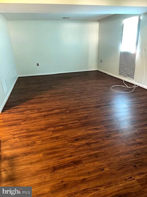 11876 Catoctin Dr, Woodbridge, VA 22192 - spare room featuring dark wood-style flooring and baseboards
