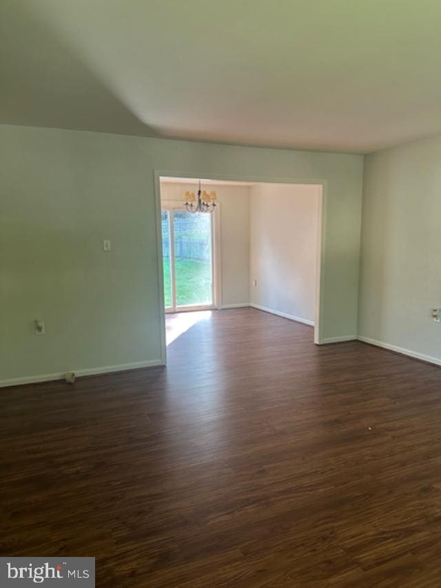 11876 Catoctin Dr, Woodbridge, VA 22192 - unfurnished room with a chandelier and dark wood-style flooring
