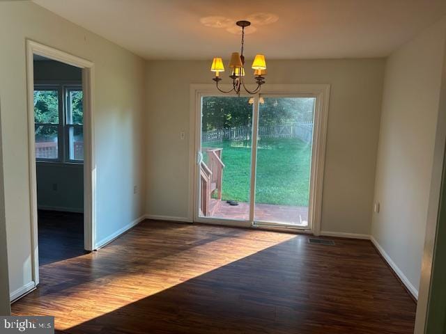 11876 Catoctin Dr, Woodbridge, VA 22192 - unfurnished dining area featuring wood finished floors and a chandelier