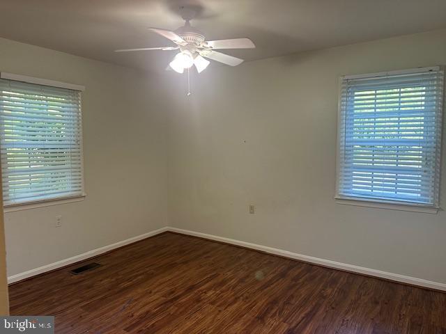 11876 Catoctin Dr, Woodbridge, VA 22192 - empty room with wood finished floors and ceiling fan