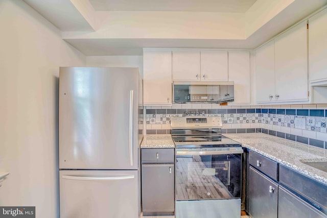 1106 Steamboat Sta, Southampton, PA 18966 - kitchen with appliances with stainless steel finishes, white cabinets, decorative backsplash, and light stone countertops