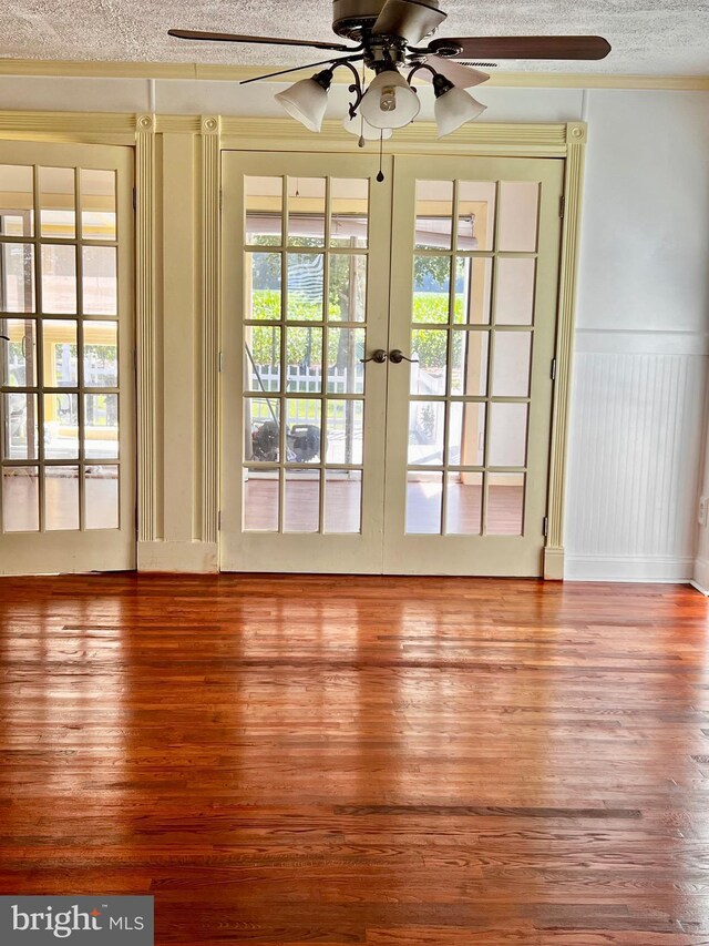 6535 Gravel Branch Rd, Hurlock, MD 21643 - doorway to outside featuring ceiling fan, wood finished floors, a textured ceiling, french doors, and a wainscoted wall