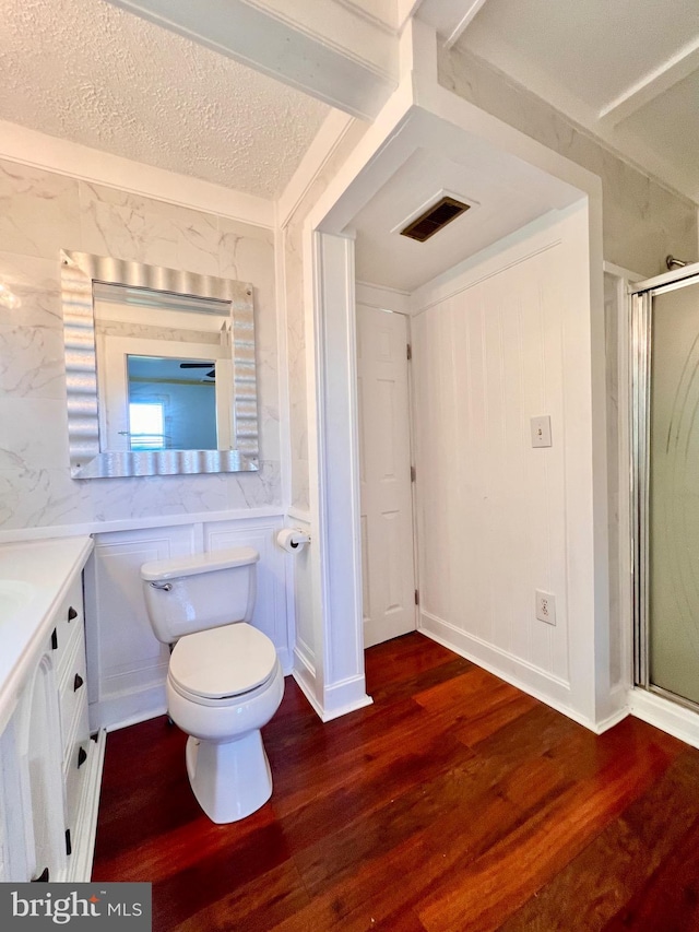 6535 Gravel Branch Rd, Hurlock, MD 21643 - bathroom featuring vanity, wood finished floors, a shower stall, and a textured ceiling