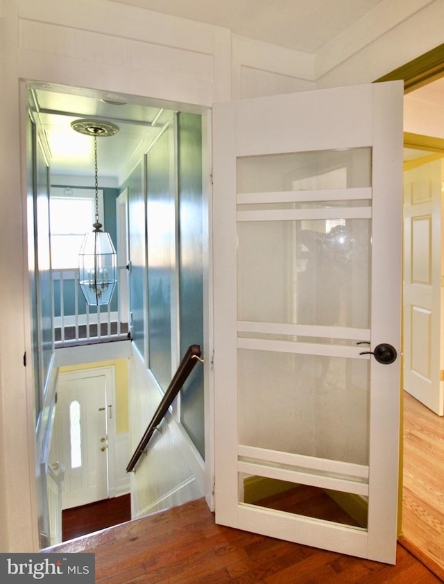 6535 Gravel Branch Rd, Hurlock, MD 21643 - stairs featuring a chandelier and wood finished floors