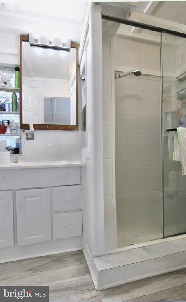 6535 Gravel Branch Rd, Hurlock, MD 21643 - bathroom with wood finished floors, a stall shower, and vanity
