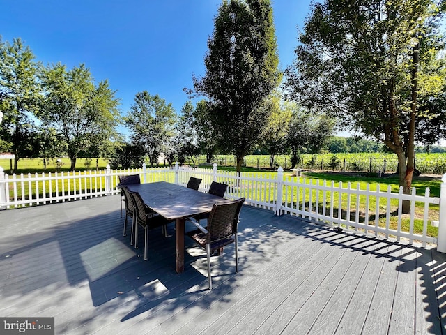 6535 Gravel Branch Rd, Hurlock, MD 21643 - wooden deck featuring outdoor dining space and a lawn