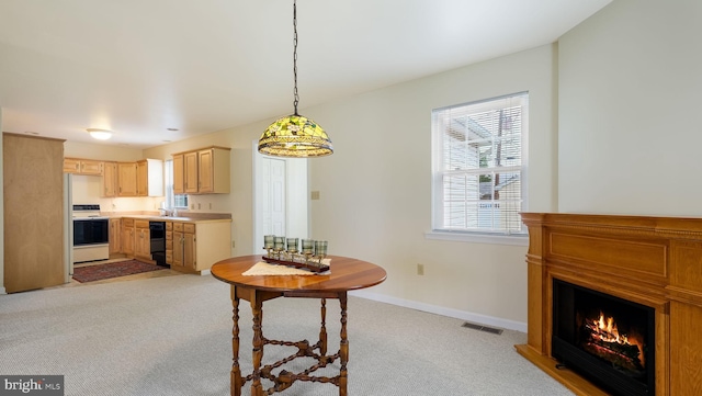 253 Roosevelt St, Bristol, PA 19007 - dining space featuring light carpet and a lit fireplace