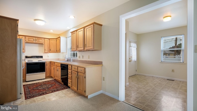 253 Roosevelt St, Bristol, PA 19007 - kitchen with white range with electric cooktop, dishwasher, light countertops, light brown cabinets, and light floors