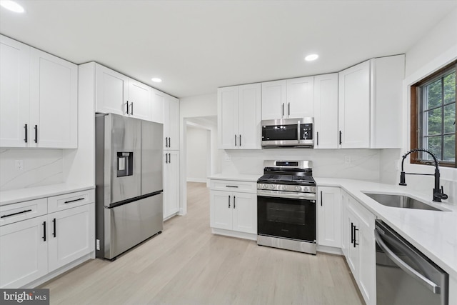932 Cropwell Rd, Cherry Hill, NJ 08003 - kitchen with stainless steel appliances, light wood finished floors, recessed lighting, tasteful backsplash, and white cabinetry