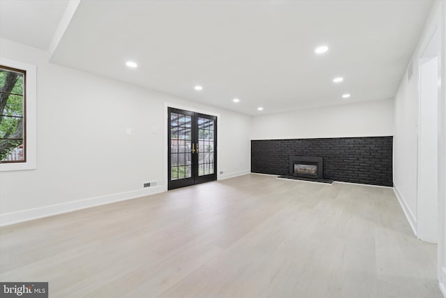 932 Cropwell Rd, Cherry Hill, NJ 08003 - unfurnished living room with french doors, a fireplace, light wood finished floors, and recessed lighting