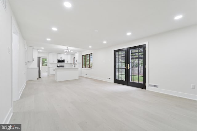 932 Cropwell Rd, Cherry Hill, NJ 08003 - unfurnished living room featuring recessed lighting, french doors, a chandelier, and light wood finished floors