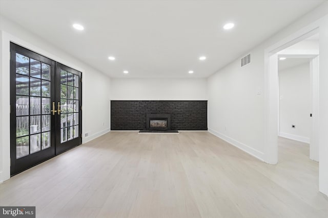 932 Cropwell Rd, Cherry Hill, NJ 08003 - unfurnished living room featuring french doors, a fireplace with raised hearth, light wood-style floors, and recessed lighting