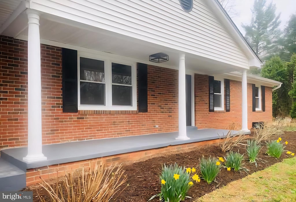7205 Silver Beech Ln, Warrenton, VA 20187 - property entrance featuring covered porch and brick siding