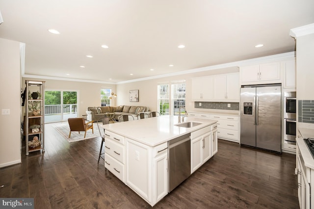 106 Pear Blossom Rd, Stafford, VA 22554 - kitchen with stainless steel appliances, crown molding, dark wood-style flooring, a center island with sink, and decorative backsplash