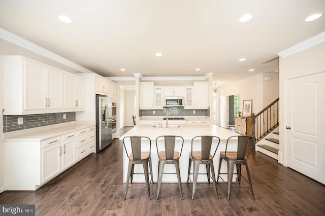 106 Pear Blossom Rd, Stafford, VA 22554 - kitchen with stainless steel fridge, a kitchen bar, ornamental molding, backsplash, and white cabinetry