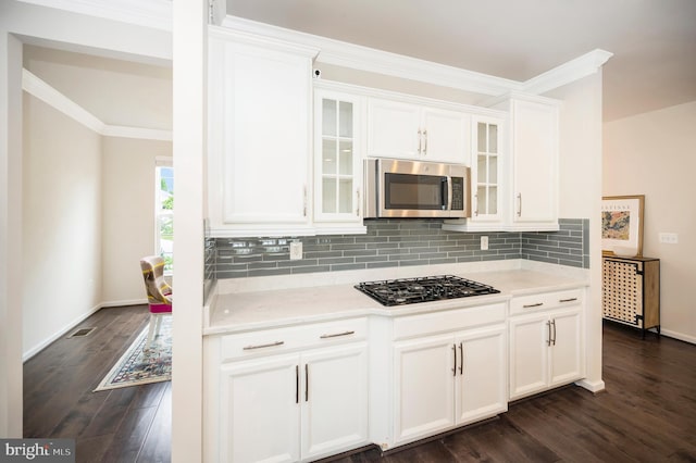 106 Pear Blossom Rd, Stafford, VA 22554 - kitchen featuring stainless steel microwave, black gas stovetop, white cabinets, dark wood-style flooring, and tasteful backsplash