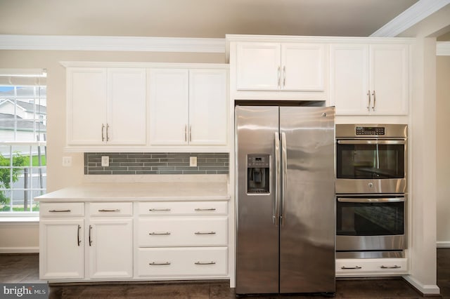 106 Pear Blossom Rd, Stafford, VA 22554 - kitchen with appliances with stainless steel finishes, white cabinets, light countertops, tasteful backsplash, and crown molding