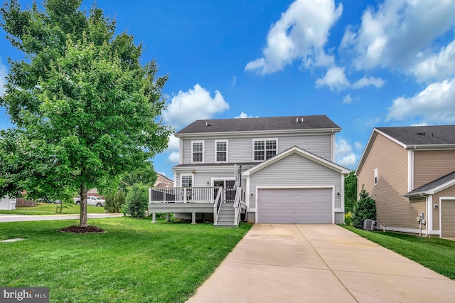 106 Pear Blossom Rd, Stafford, VA 22554 - view of front of home with concrete driveway, a deck, a front lawn, and an attached garage