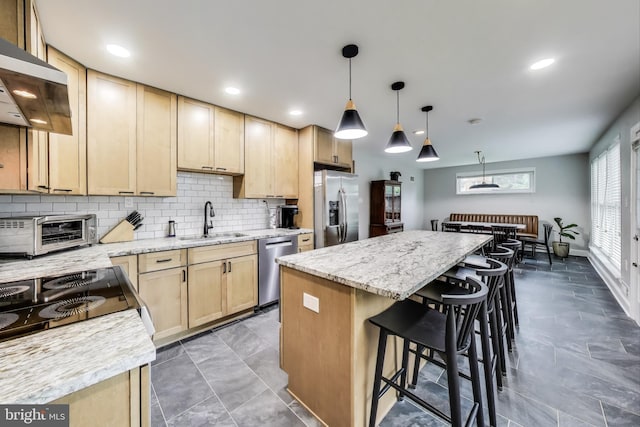13000 Daley St, Silver Spring, MD 20906 - kitchen featuring ventilation hood, stainless steel appliances, light brown cabinetry, tasteful backsplash, and a breakfast bar area
