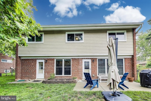 13000 Daley St, Silver Spring, MD 20906 - rear view of property with brick siding, a lawn, and a patio