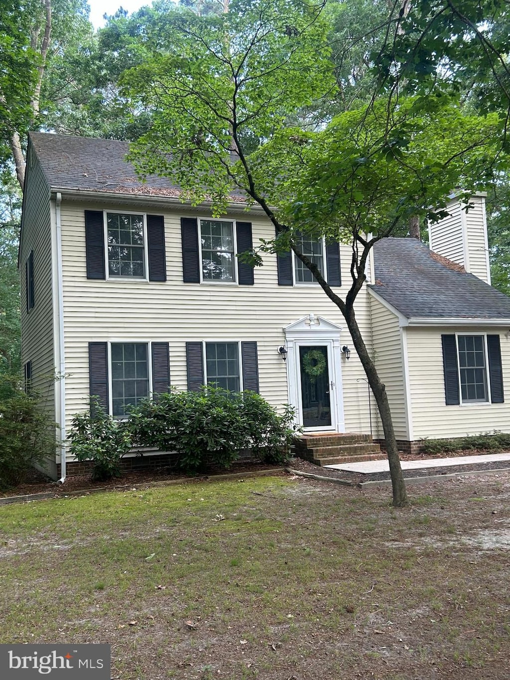 818 Outten Rd, Salisbury, MD 21804 - colonial house featuring a chimney, a front yard, and a shingled roof