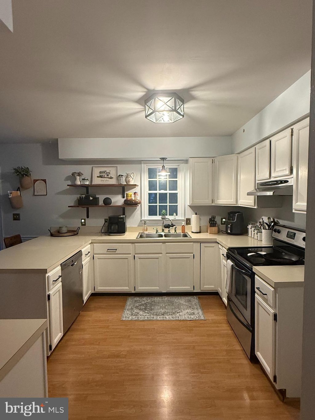 818 Outten Rd, Salisbury, MD 21804 - kitchen featuring stainless steel appliances, under cabinet range hood, light countertops, and white cabinetry