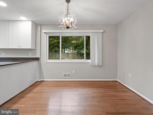 5415 Juliet St, Springfield, VA 22151 - unfurnished dining area featuring wood finished floors and a chandelier