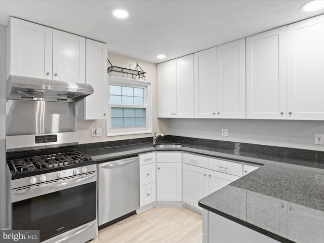 5415 Juliet St, Springfield, VA 22151 - kitchen with stainless steel appliances, under cabinet range hood, white cabinets, recessed lighting, and dark stone counters