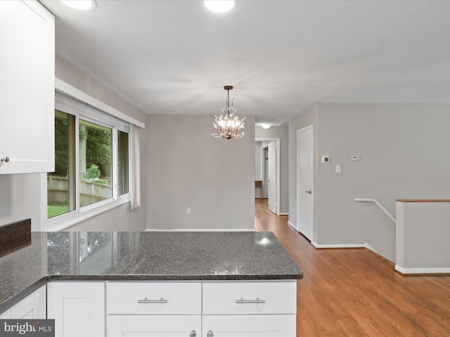 5415 Juliet St, Springfield, VA 22151 - kitchen featuring white cabinets, light wood-style floors, a chandelier, a peninsula, and dark stone countertops
