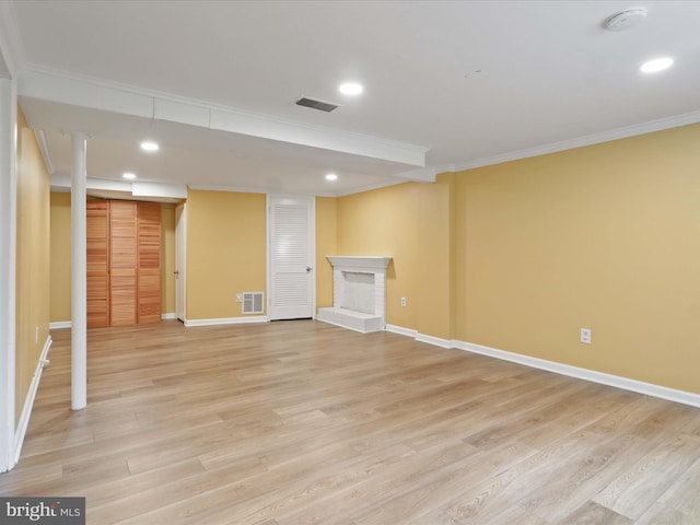 5415 Juliet St, Springfield, VA 22151 - finished basement with crown molding, light wood-style flooring, recessed lighting, and a fireplace